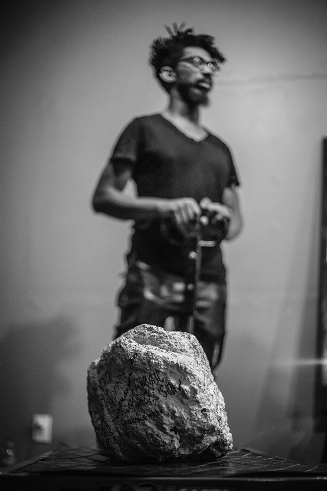 Andre Henry carrying a boulder